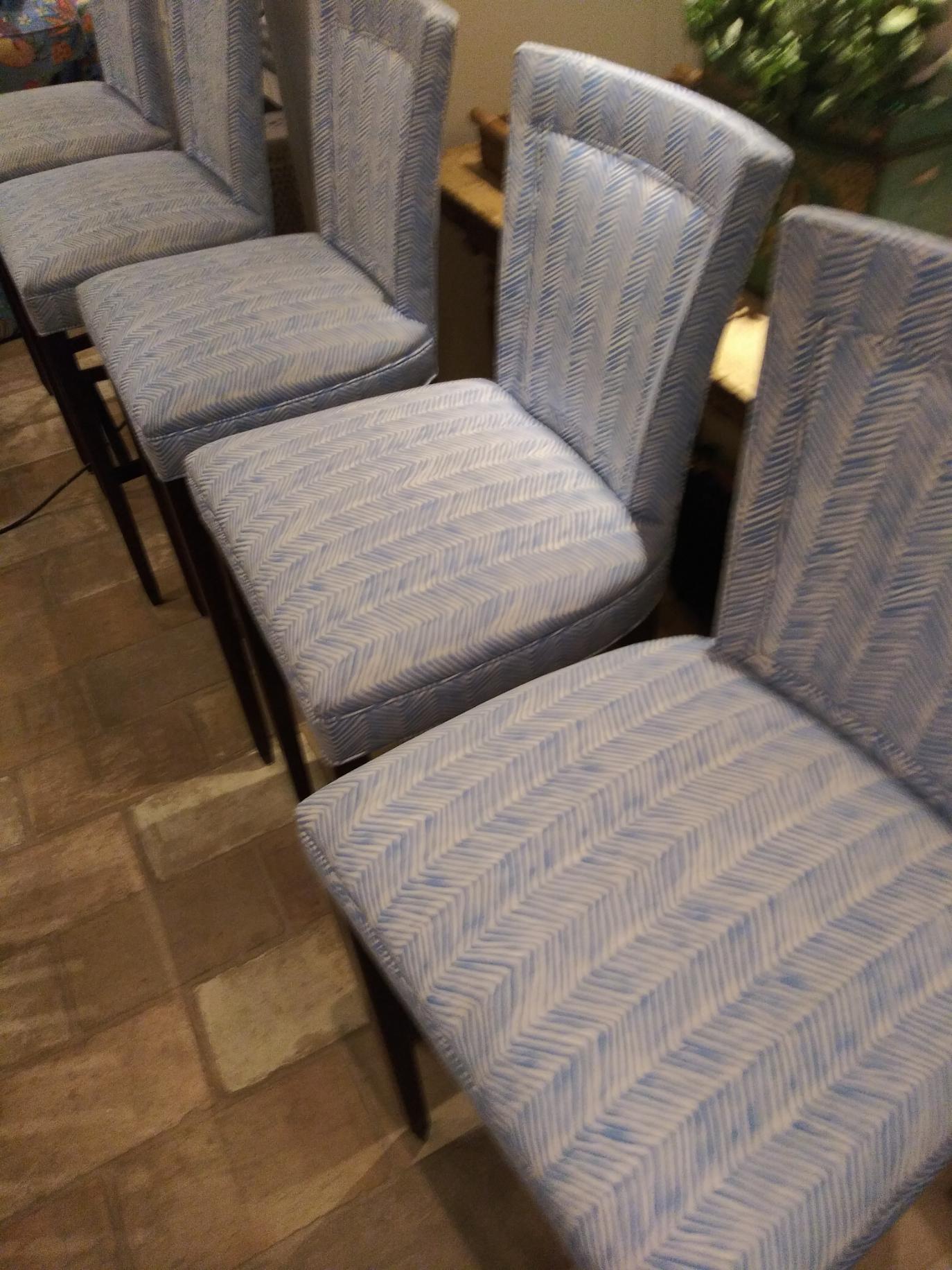 A row of chairs sitting next to each other on a wooden floor.