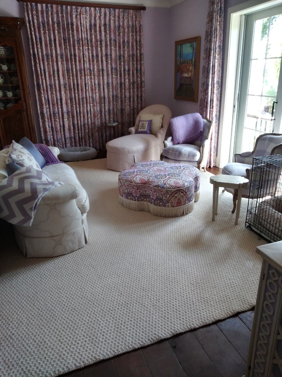 A living room filled with furniture and a rug.