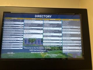Digital directory screen in the Rockledge Building, 1600 Harrison Avenue, Mamaroneck, NY, listing various office tenants.