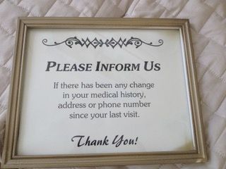A framed sign with a decorative header, reading: 