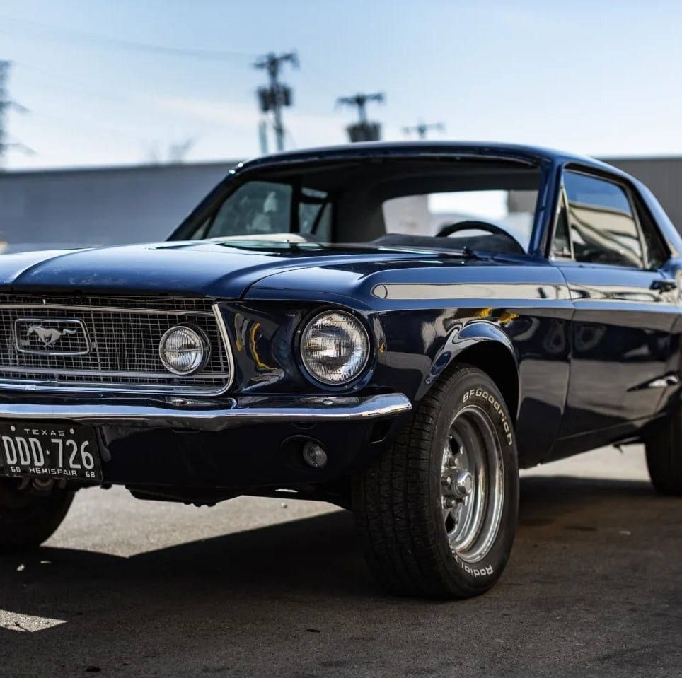 Dark blue vintage Ford Mustang coupe.