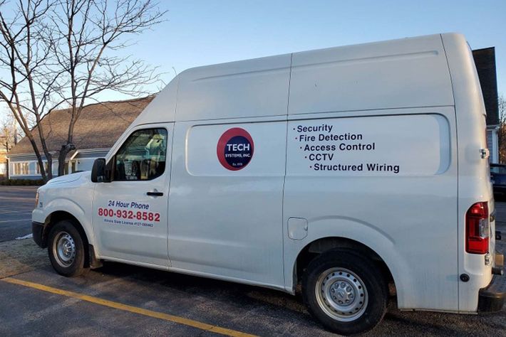 A white van is parked in a parking lot.