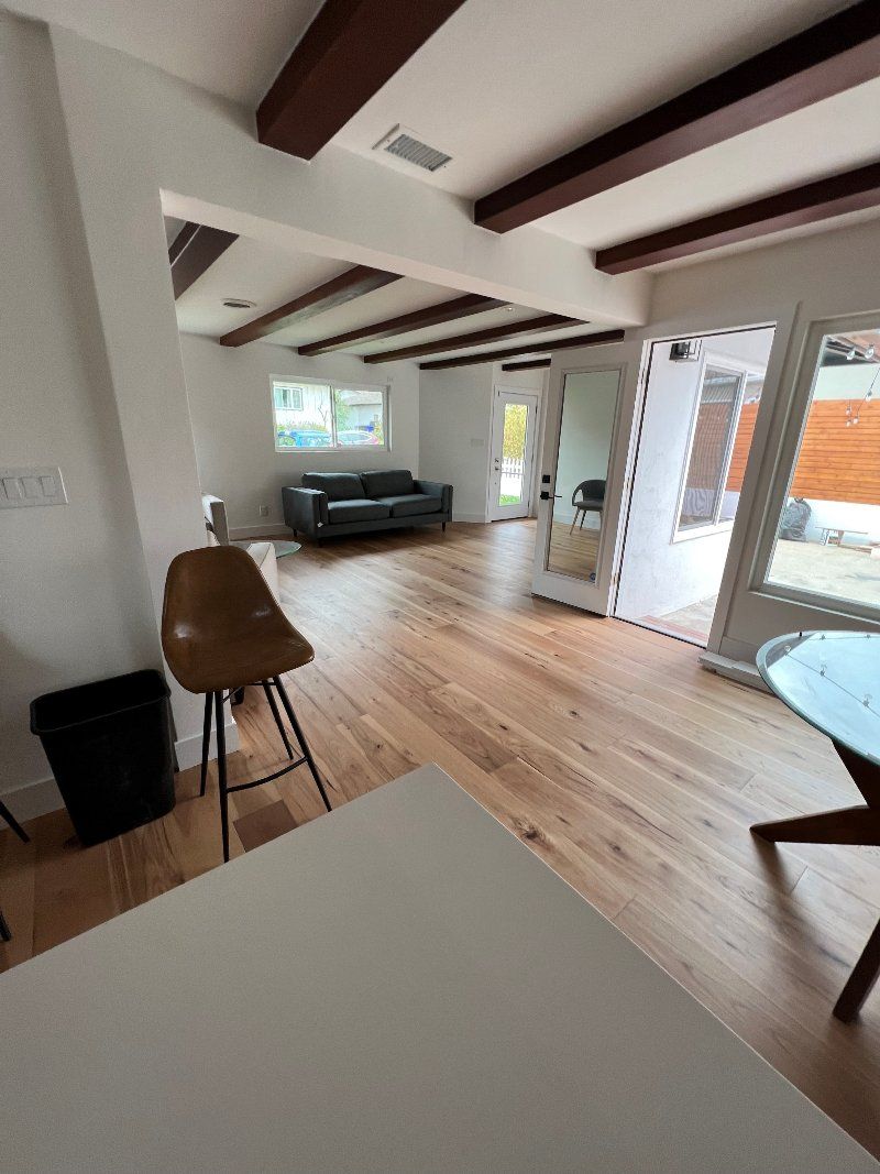A living room with hardwood floors and a couch.