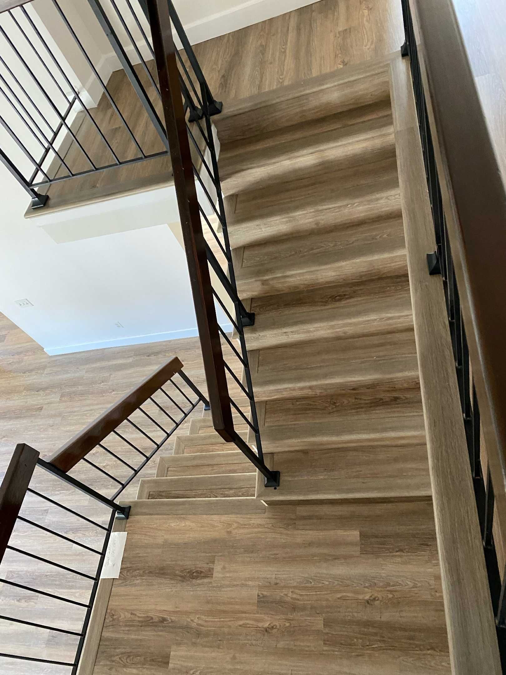 A staircase with wooden steps and a metal railing in a house.