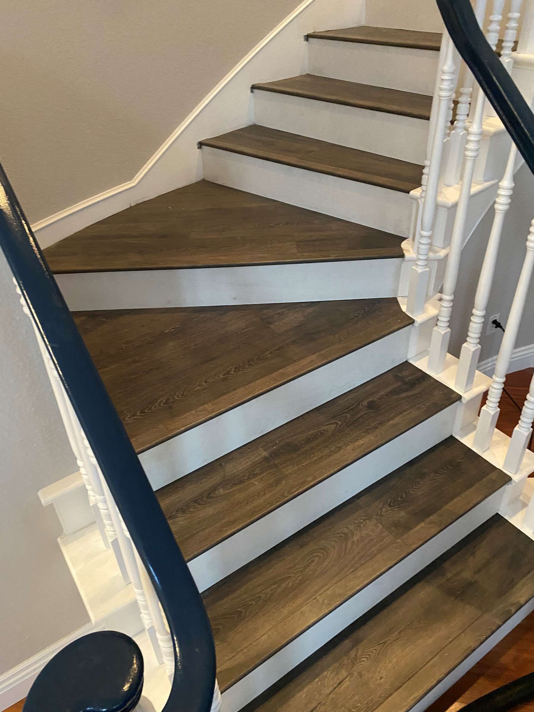 A staircase with wooden steps and a blue railing.