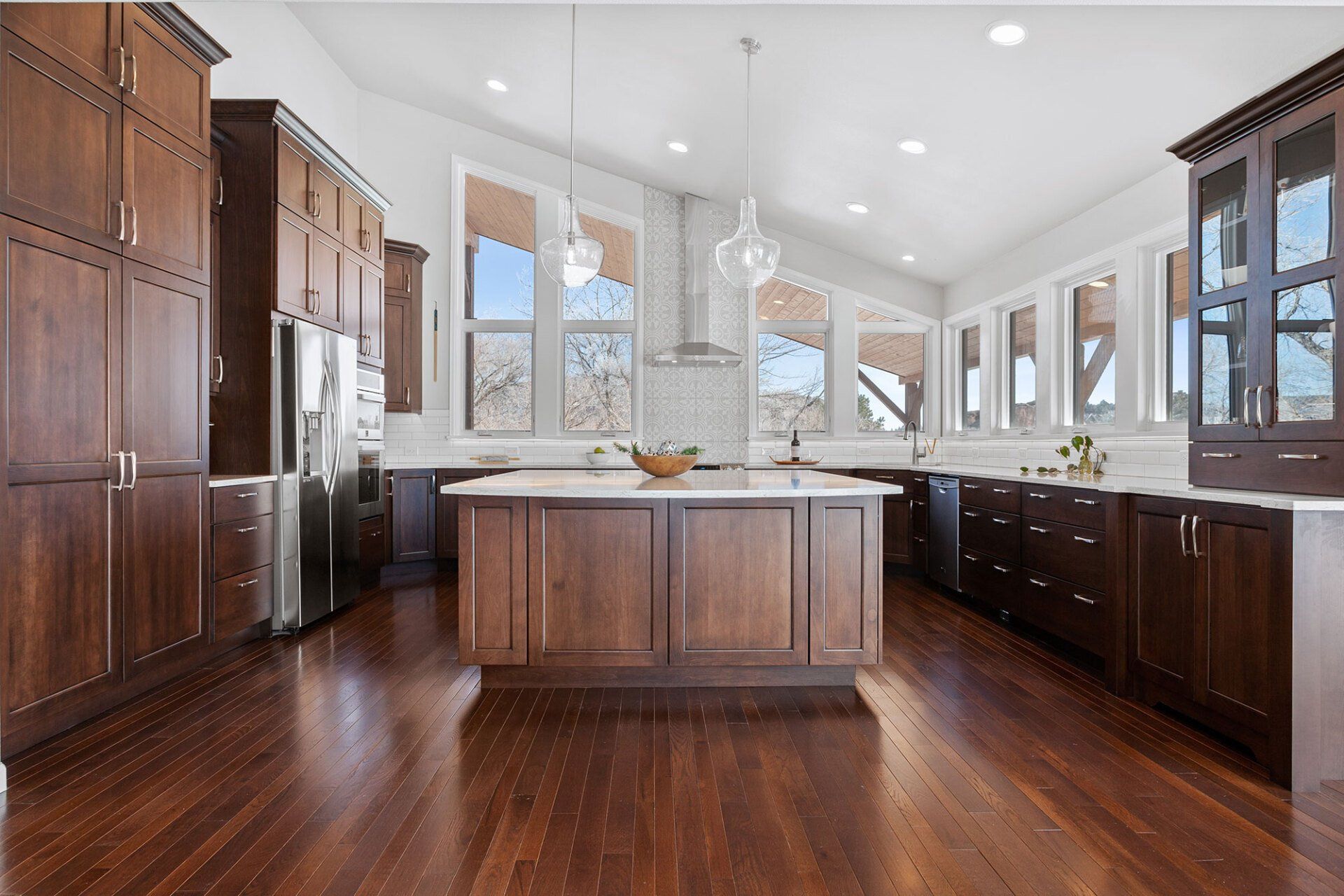 A large kitchen with wooden cabinets and stainless steel appliances.