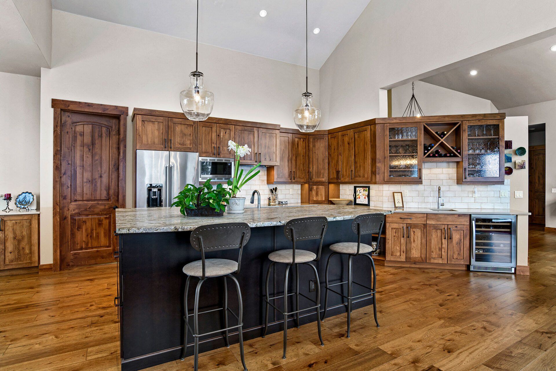 A large kitchen with a large island and stools.