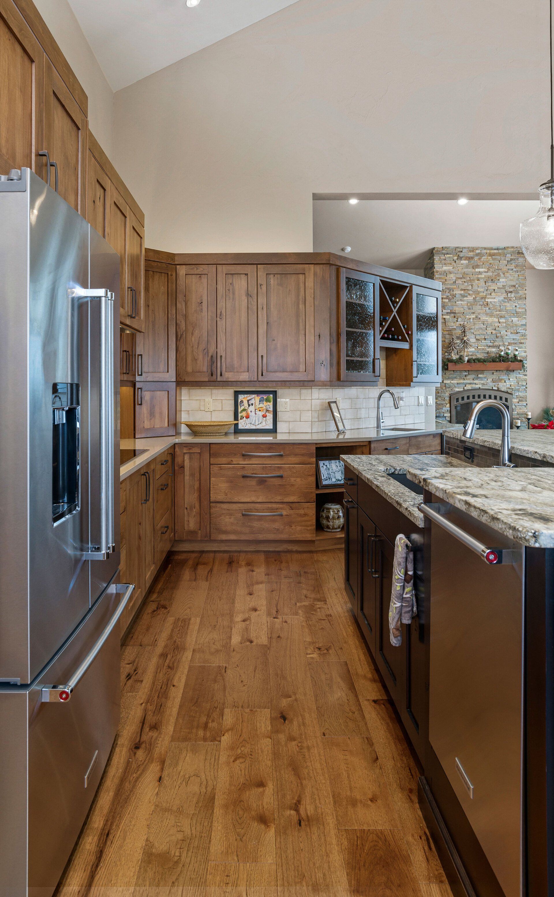 A kitchen with stainless steel appliances and wooden cabinets.