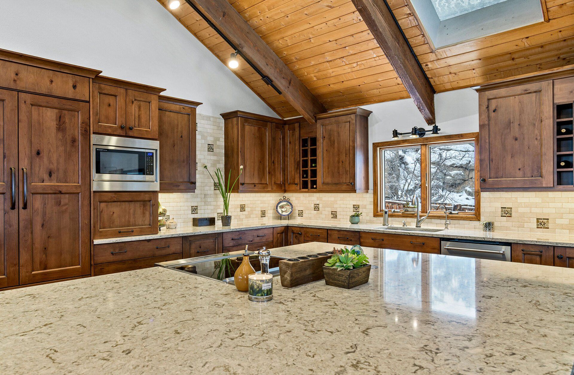 A kitchen with wooden cabinets and granite counter tops