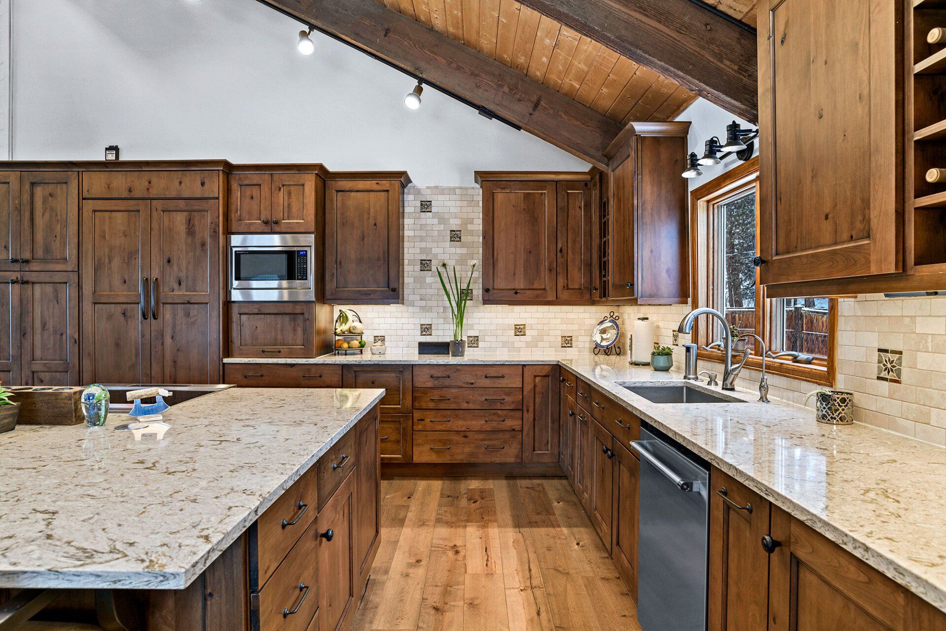 A kitchen with wooden cabinets and granite counter tops