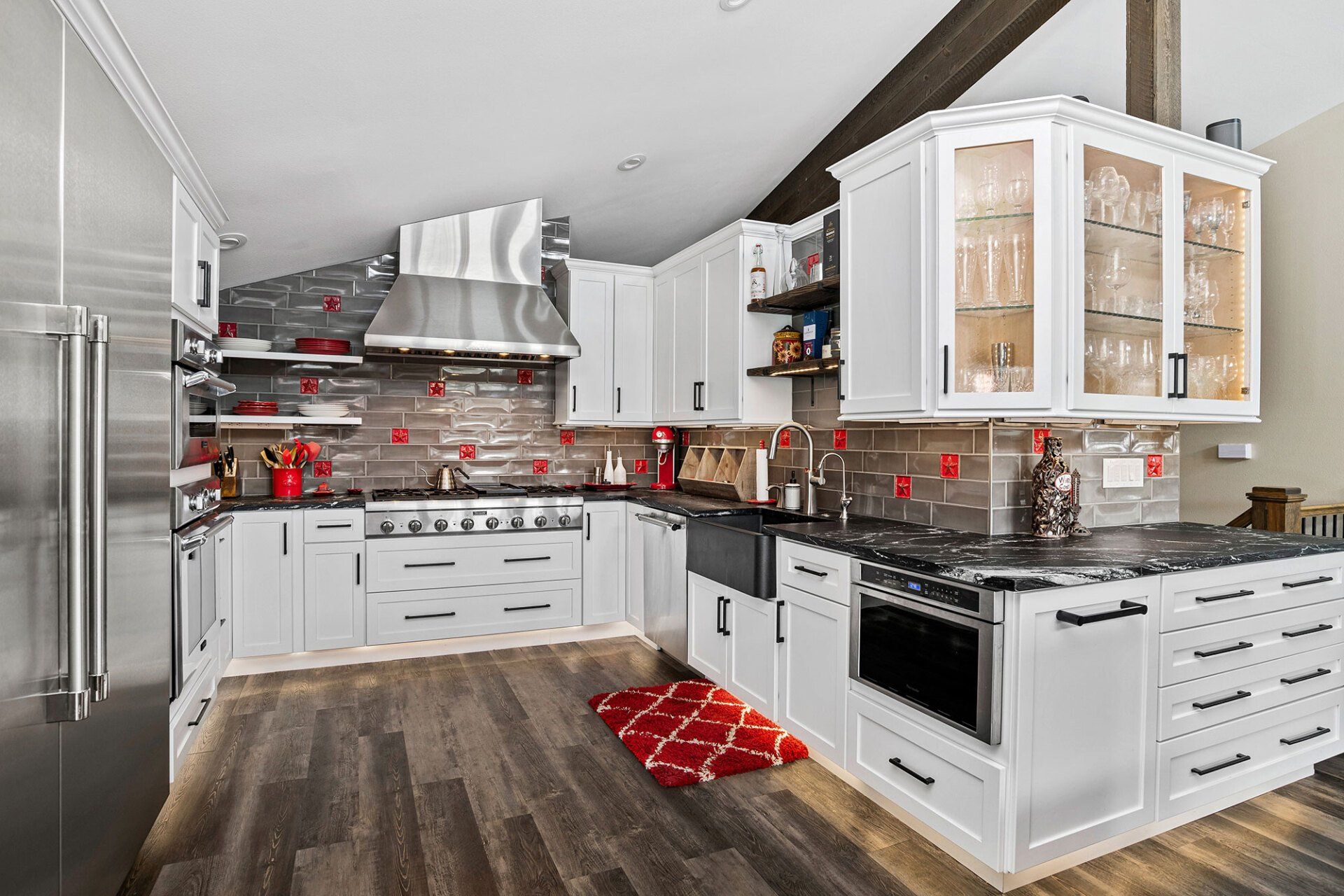 A kitchen with white cabinets and stainless steel appliances.