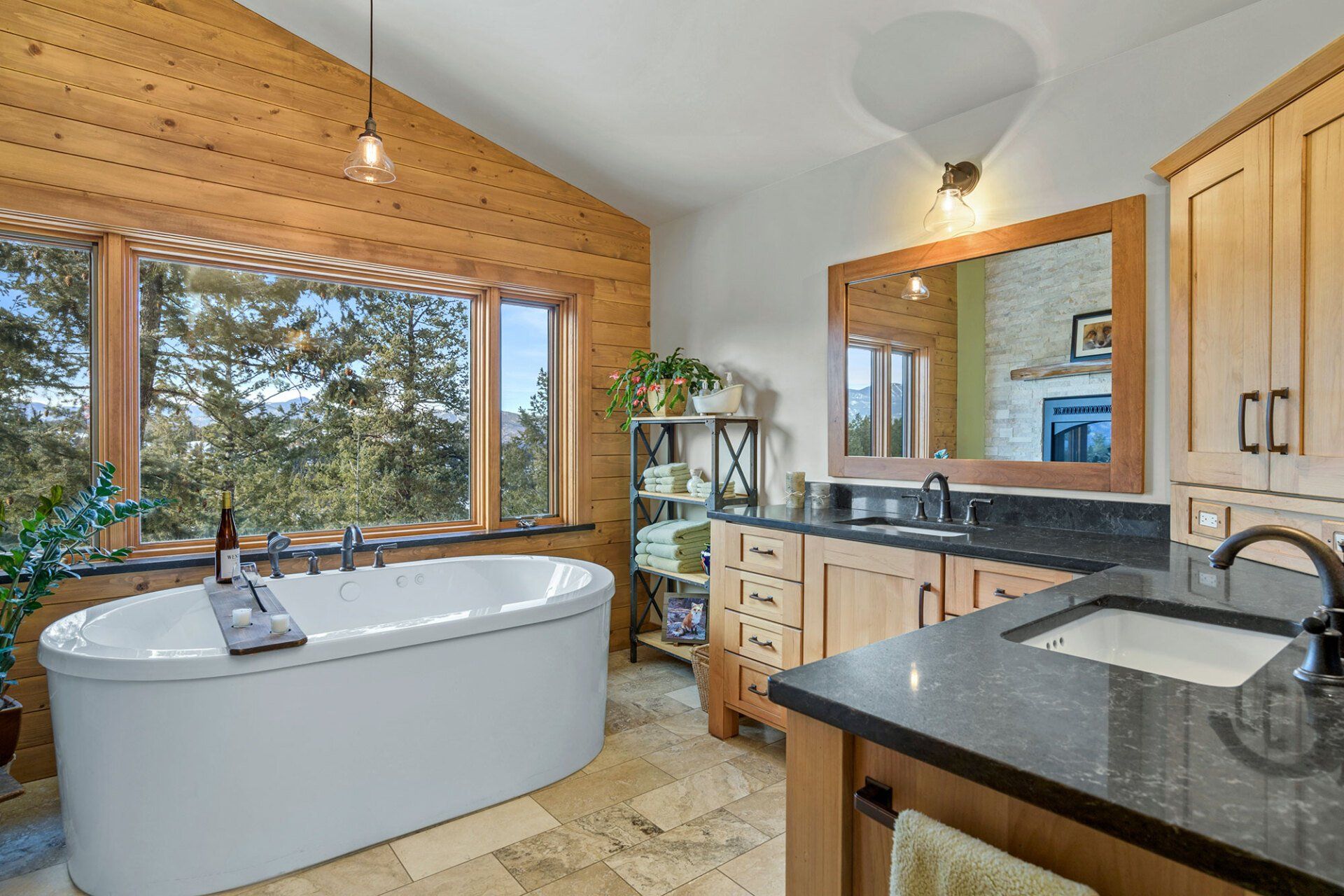 A bathroom with a tub , sink , mirror and wooden cabinets.