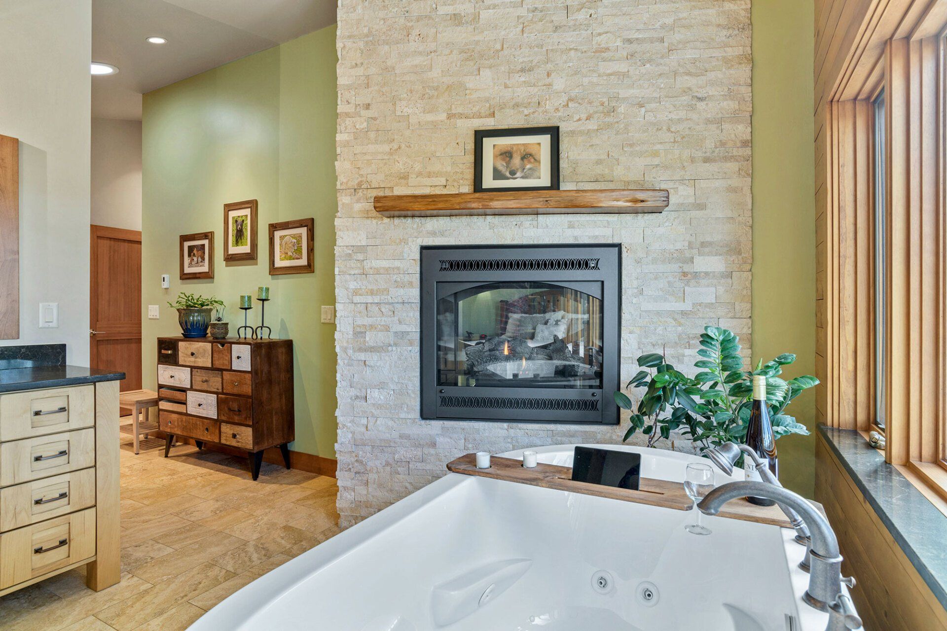 A bathroom with a jacuzzi tub and a fireplace.