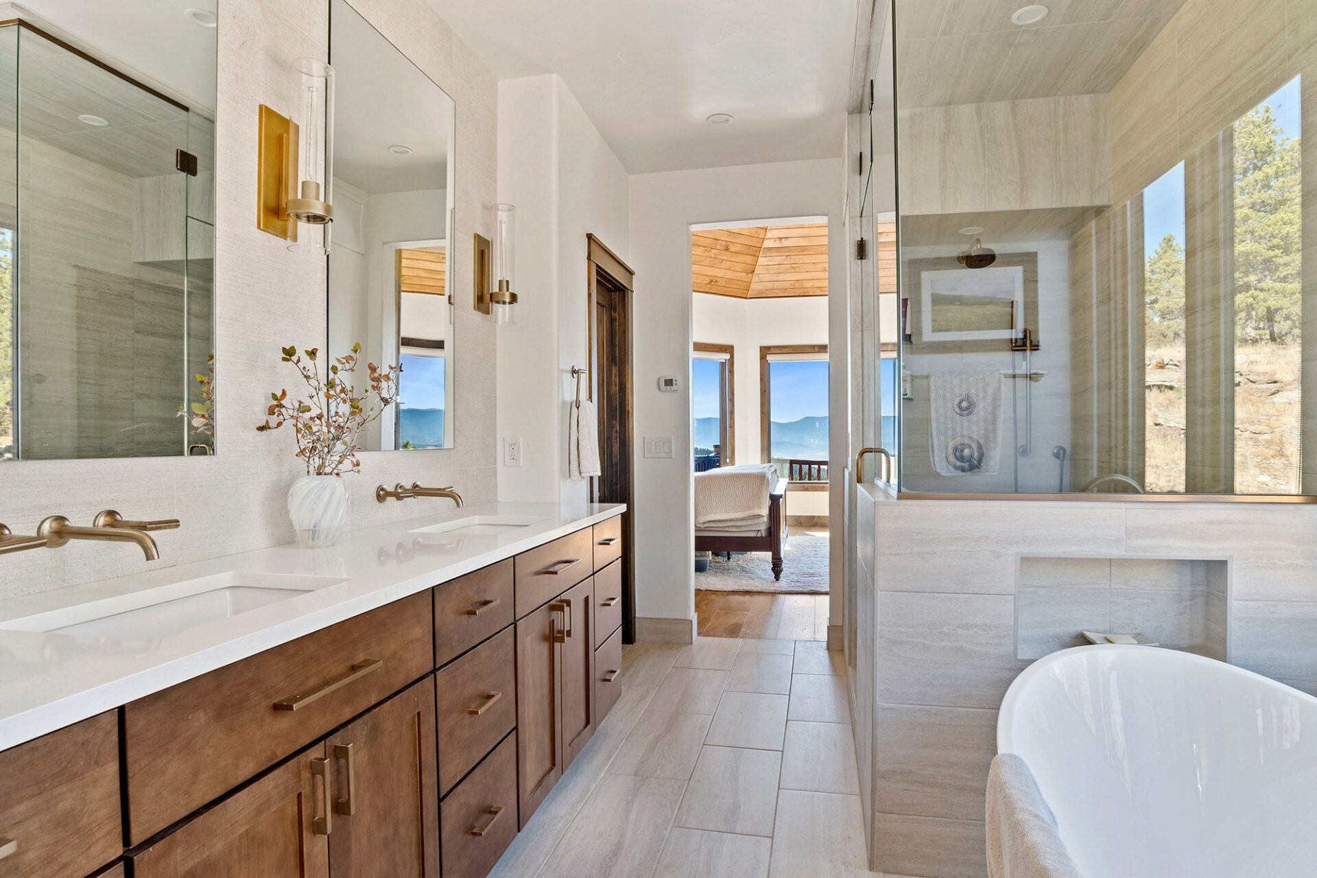 A bathroom with two sinks , a tub and a walk in shower.