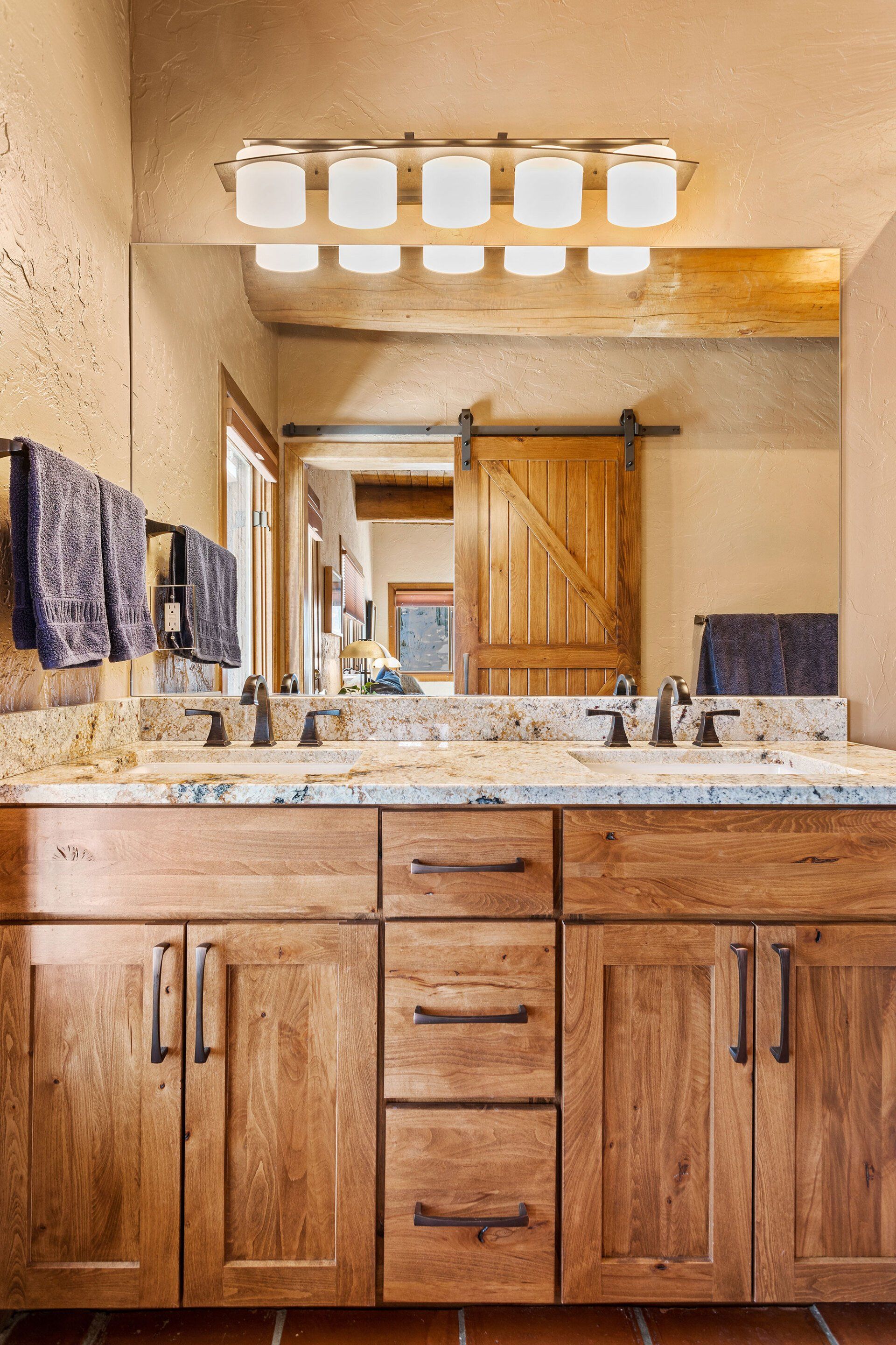 A bathroom with two sinks and a large mirror.