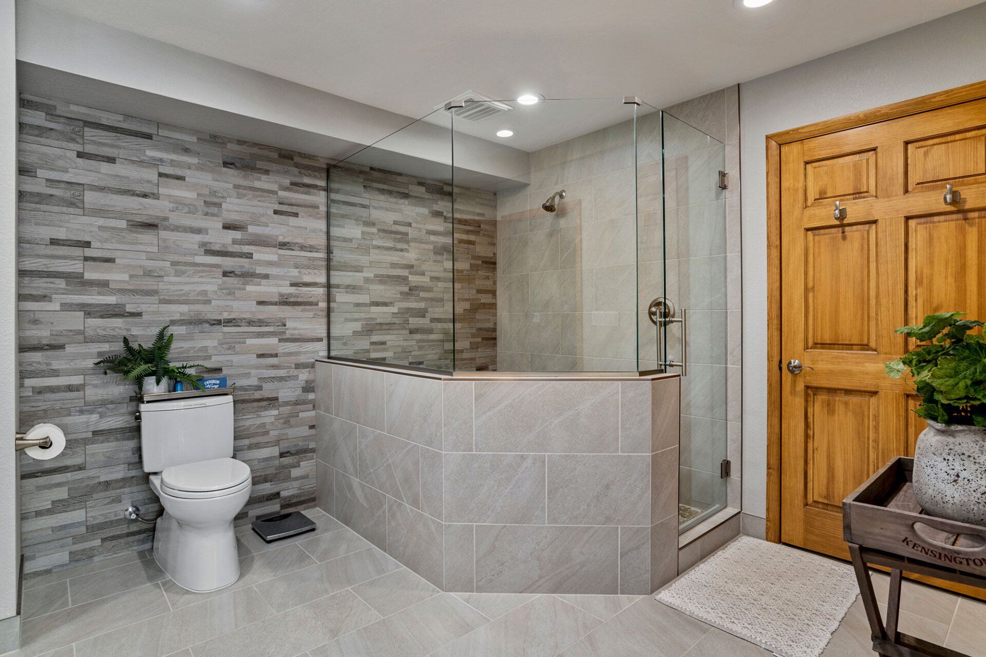 A bathroom with a toilet , shower and bathtub.
