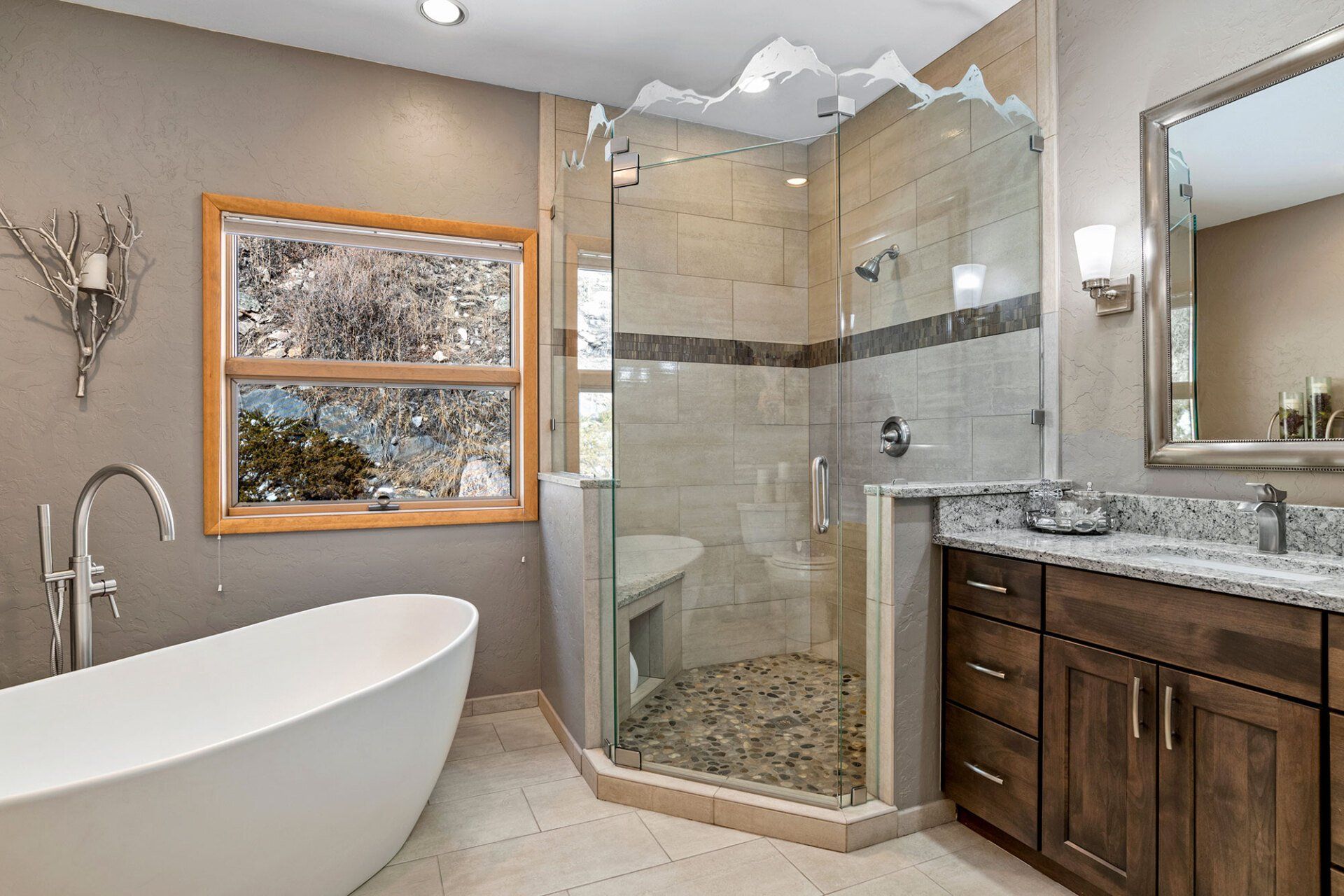 A bathroom with a tub , sink , mirror and walk in shower.