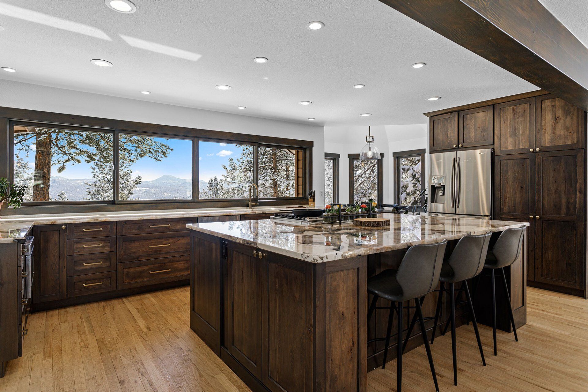 A large kitchen with a large island in the middle and a lot of windows.