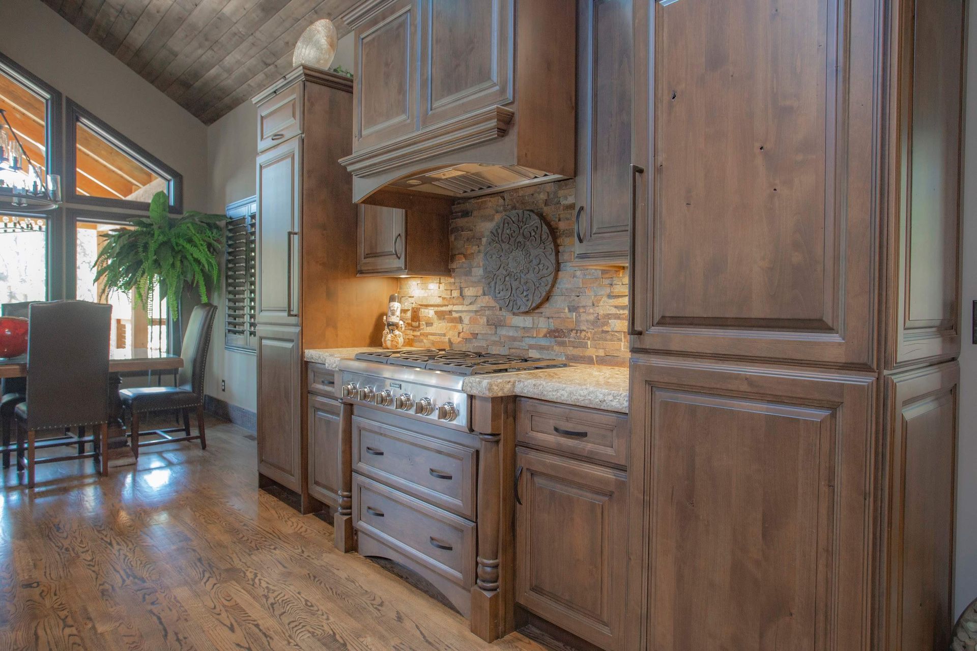 A kitchen with wooden cabinets , a stove and a refrigerator.