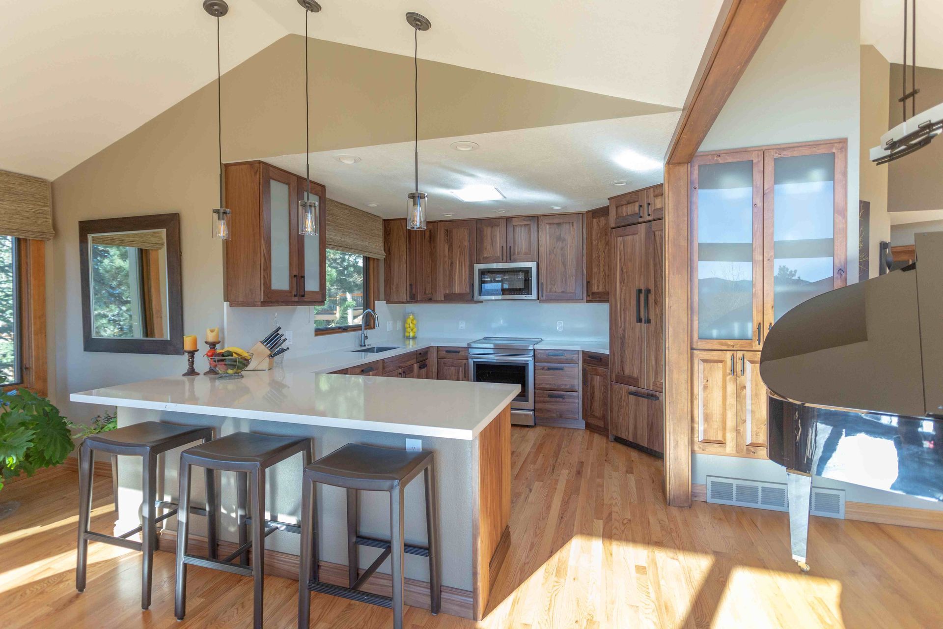 A kitchen with a large island and stools in it