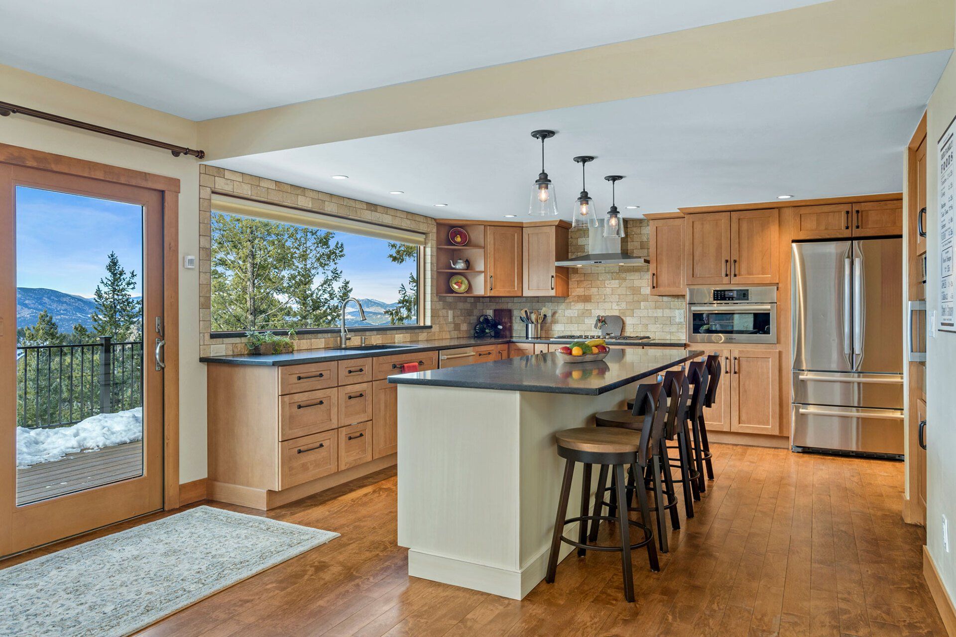 A kitchen with stainless steel appliances and wooden cabinets