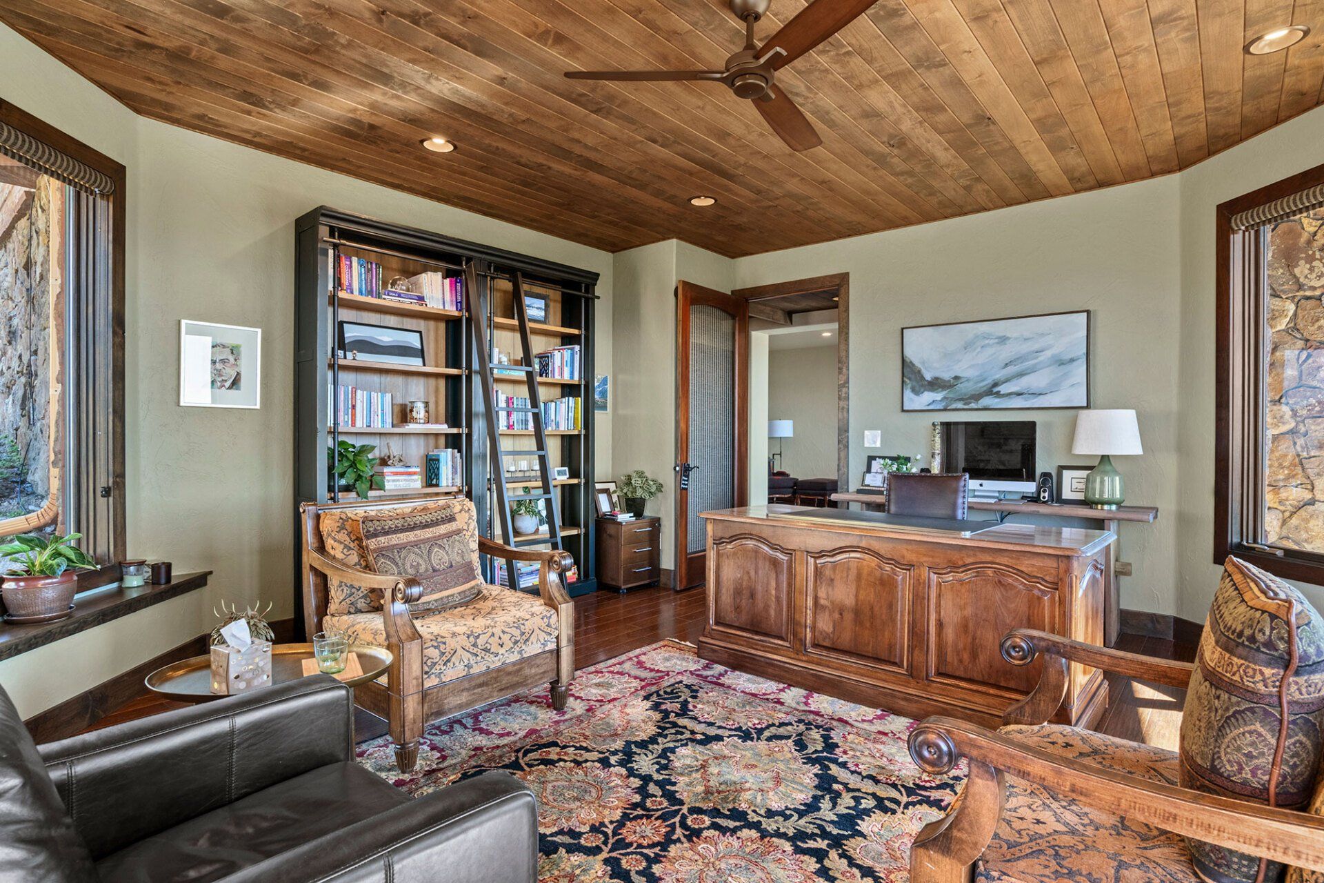 A living room filled with furniture and a ceiling fan.