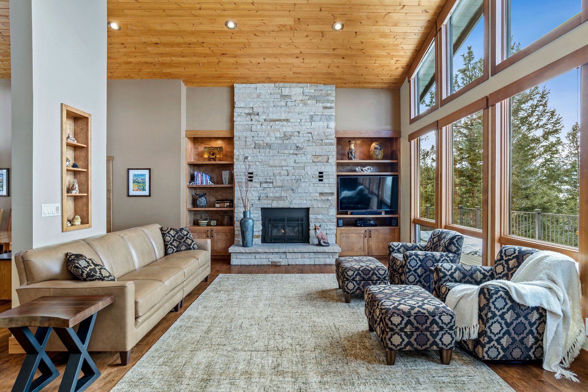 A living room with a couch , chairs , and a fireplace.