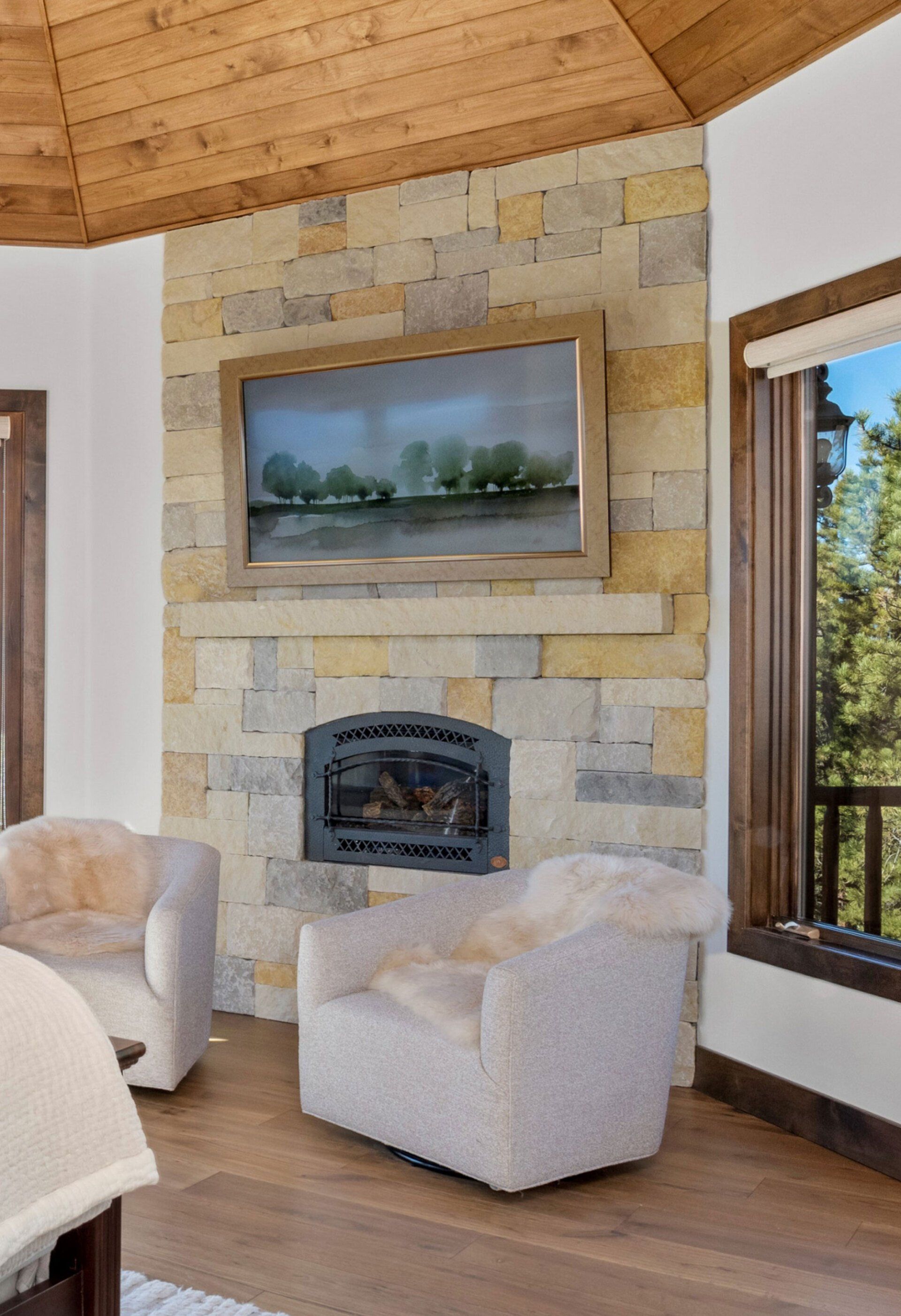 A living room with a fireplace and a television on the wall