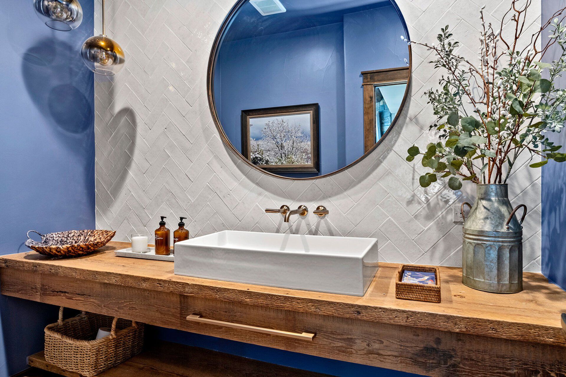 A bathroom with a sink , mirror and wooden counter top.