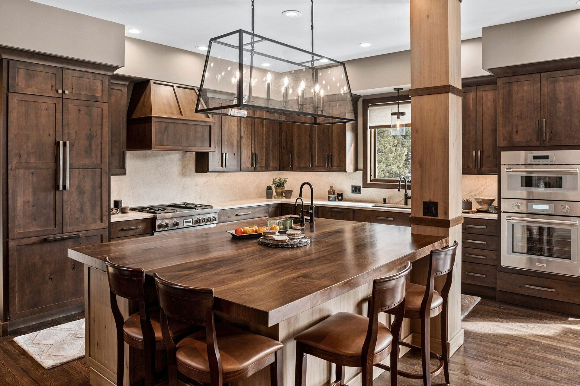 A kitchen with a large wooden table and chairs.