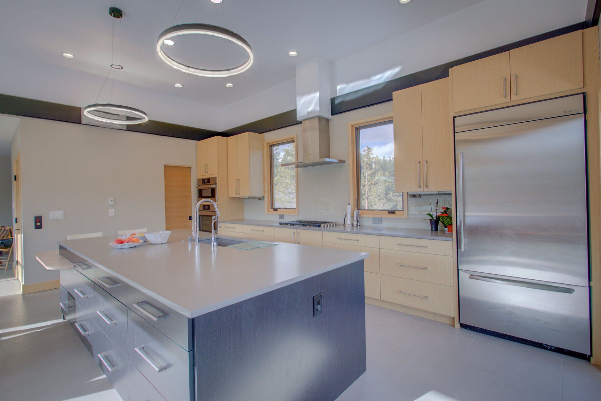 A kitchen with stainless steel appliances and a large island.