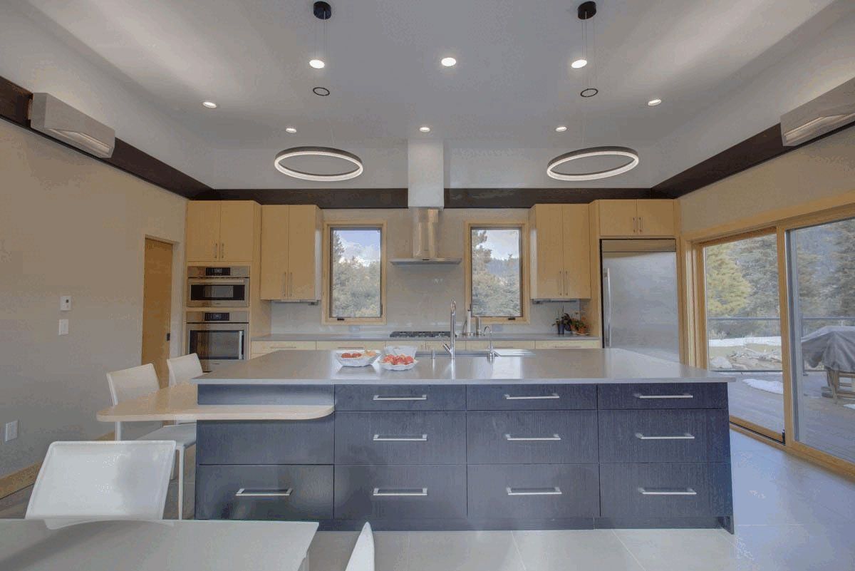 A kitchen with a large island and stainless steel appliances.