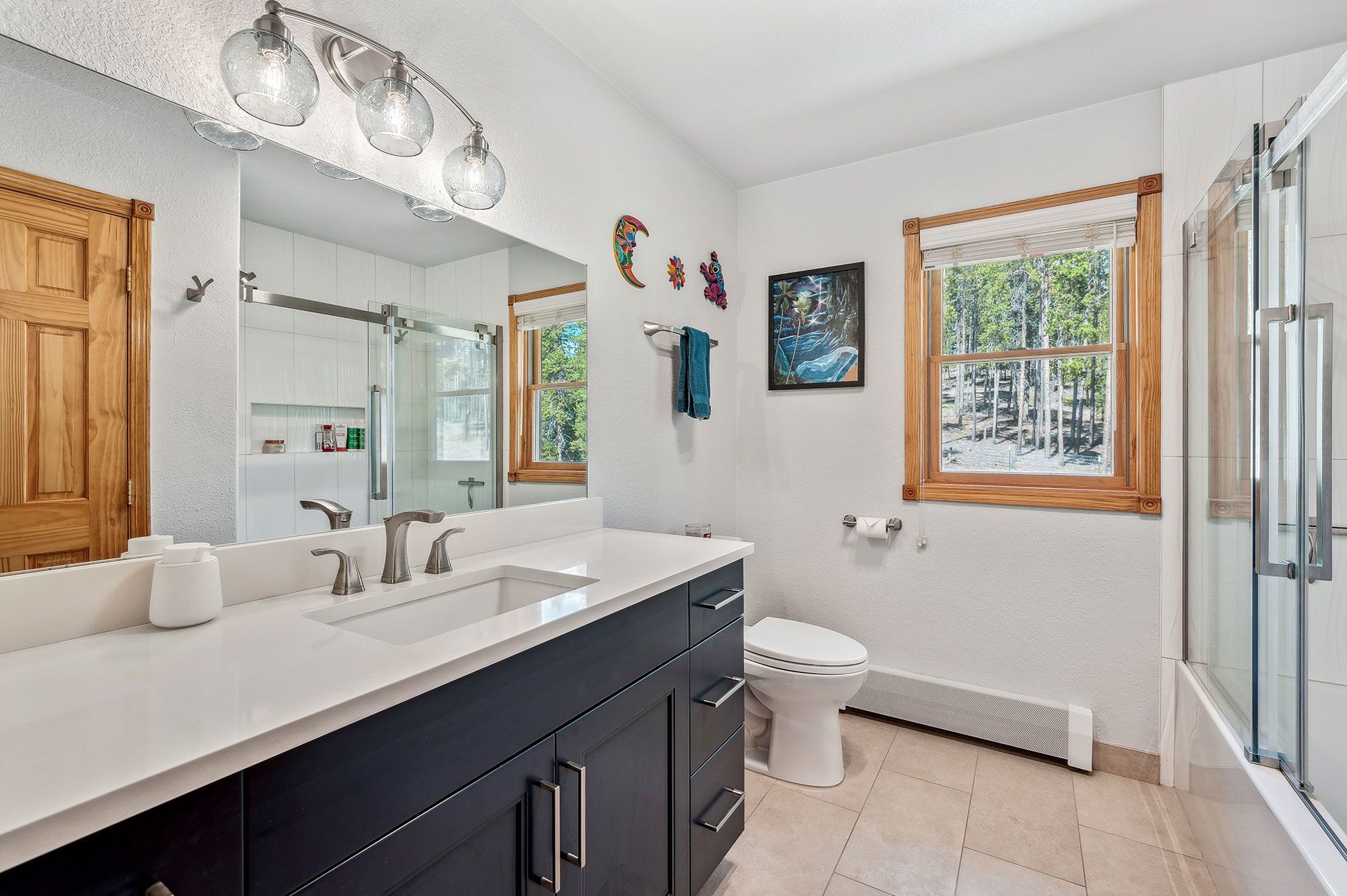 A bathroom with a sink , toilet , and shower.