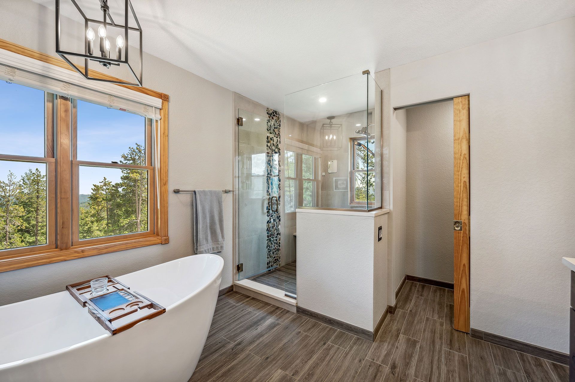 A bathroom with a tub and a walk in shower.