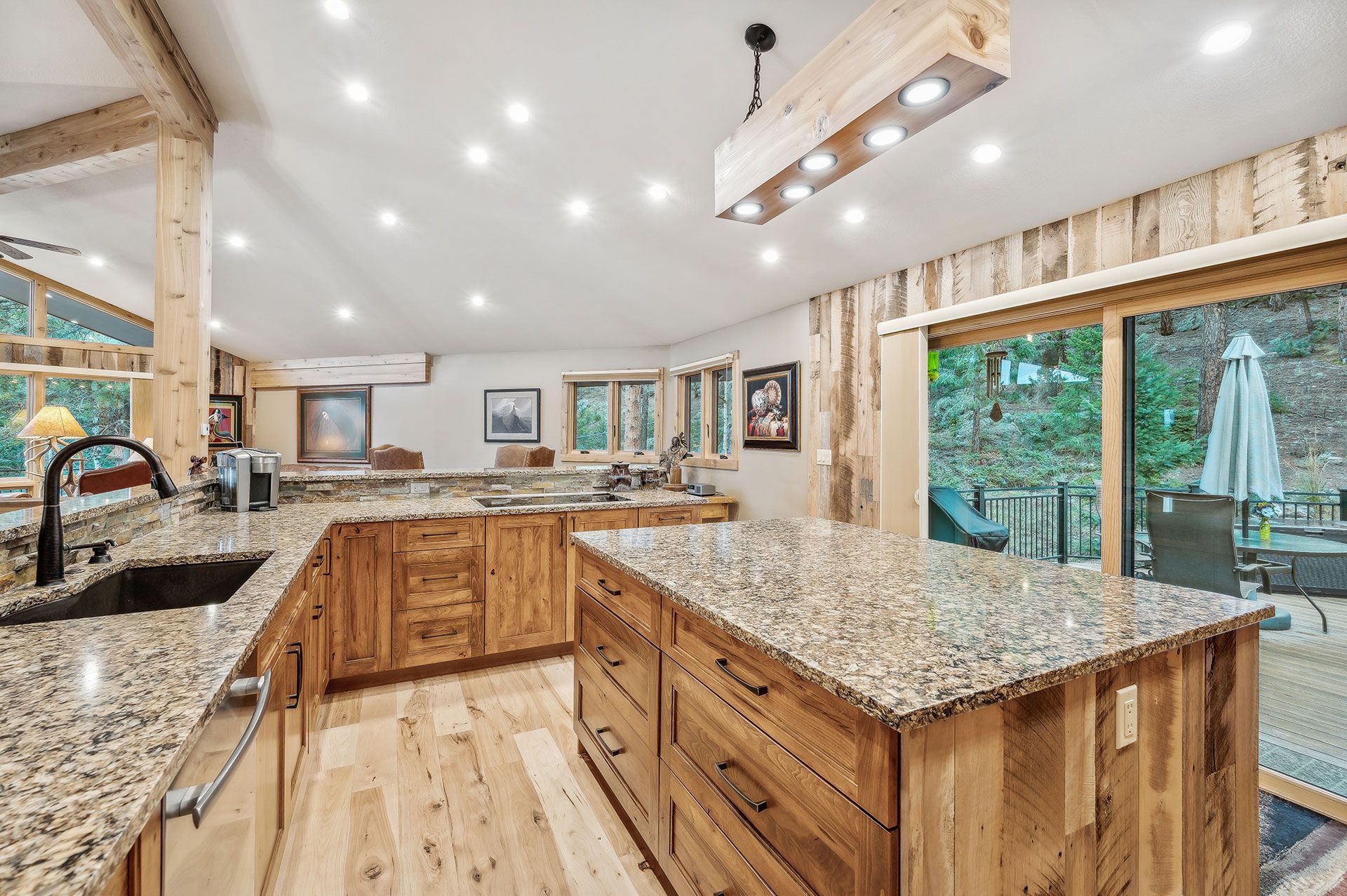 A kitchen with granite counter tops and wooden cabinets.