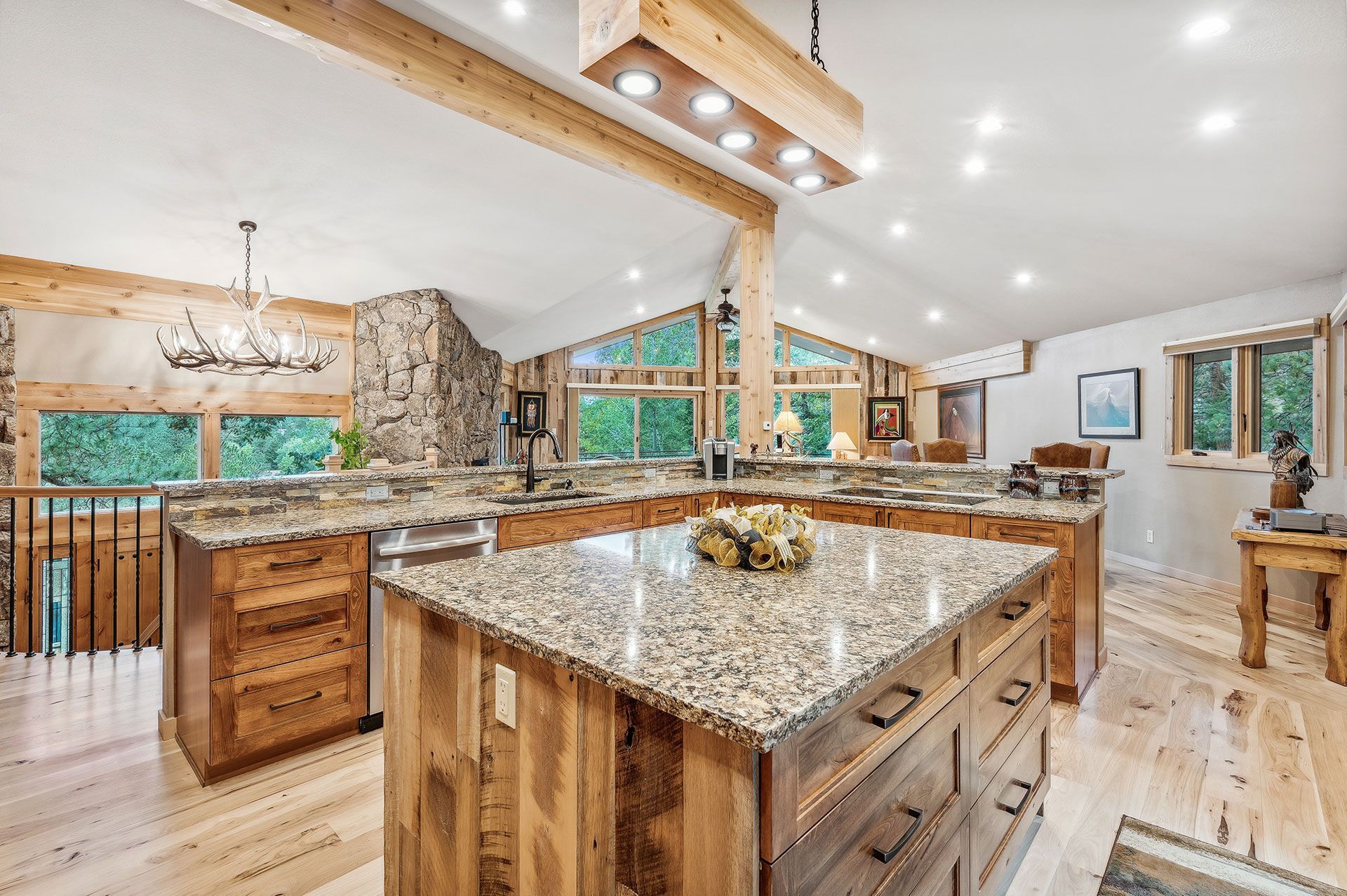 A large kitchen with granite counter tops and wooden cabinets