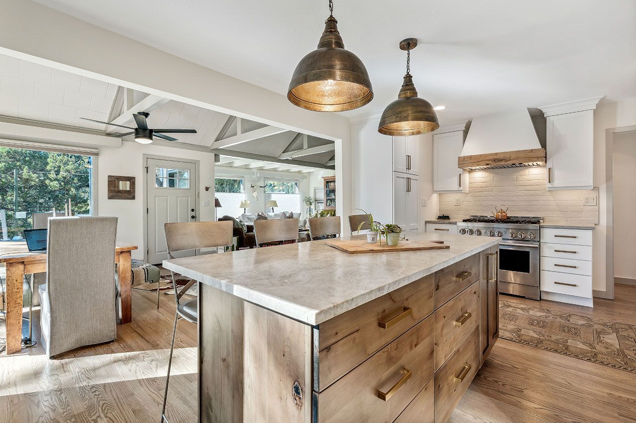 A kitchen with a large island and stainless steel appliances.