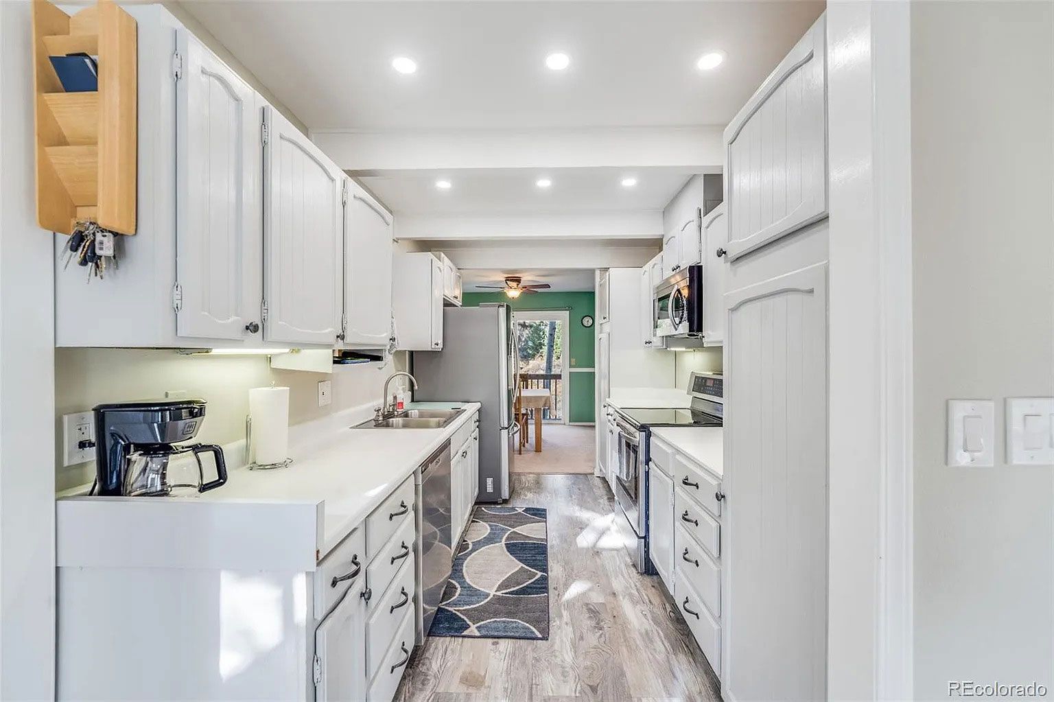 A kitchen with white cabinets and stainless steel appliances.