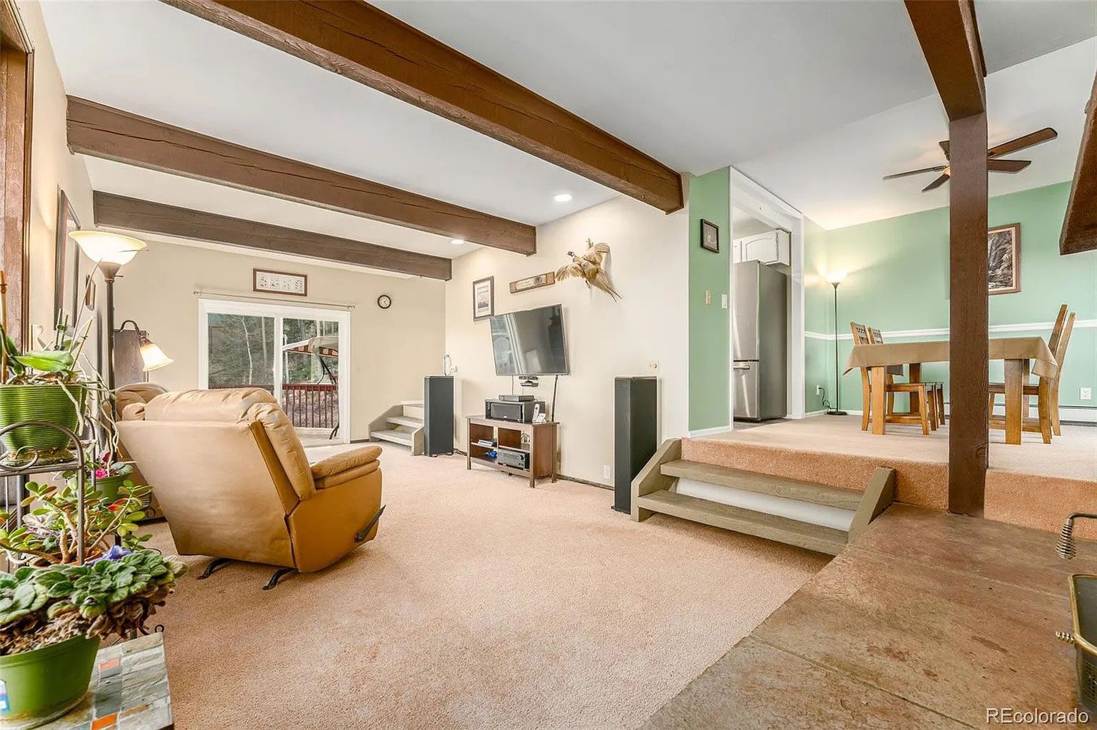A living room with a couch, chair, and television