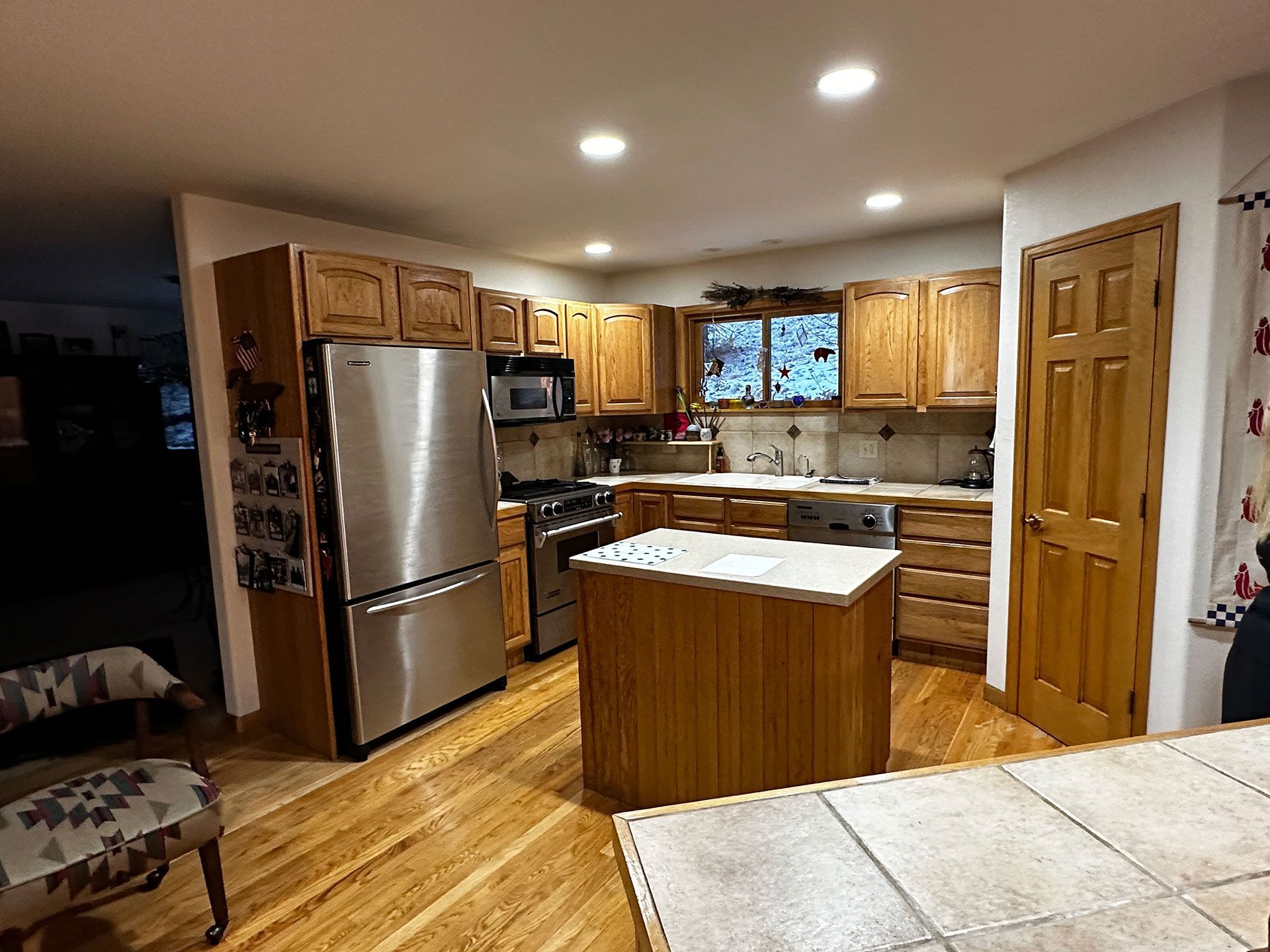 A kitchen with stainless steel appliances and wooden cabinets.