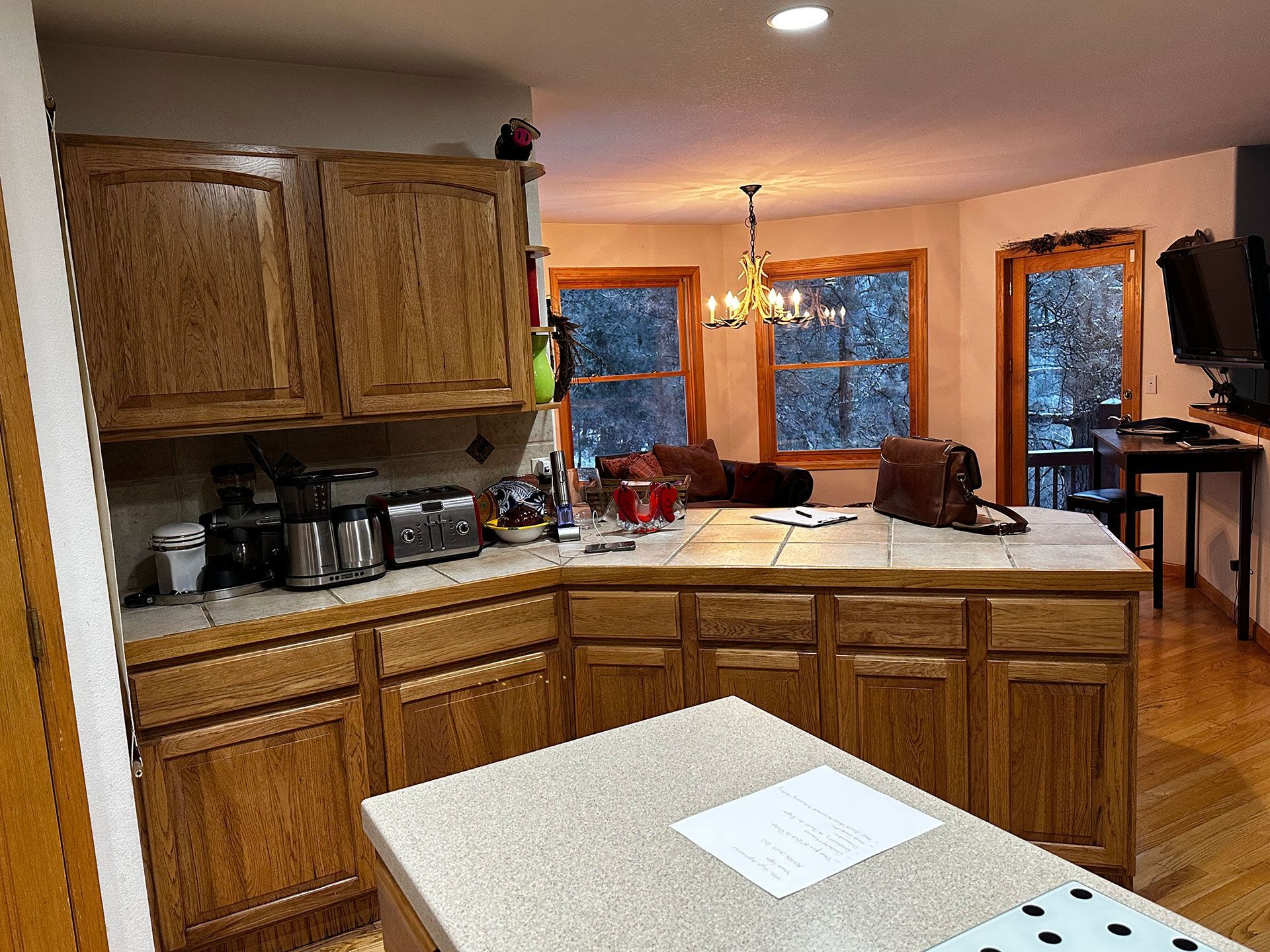 A kitchen with wooden cabinets and granite counter tops