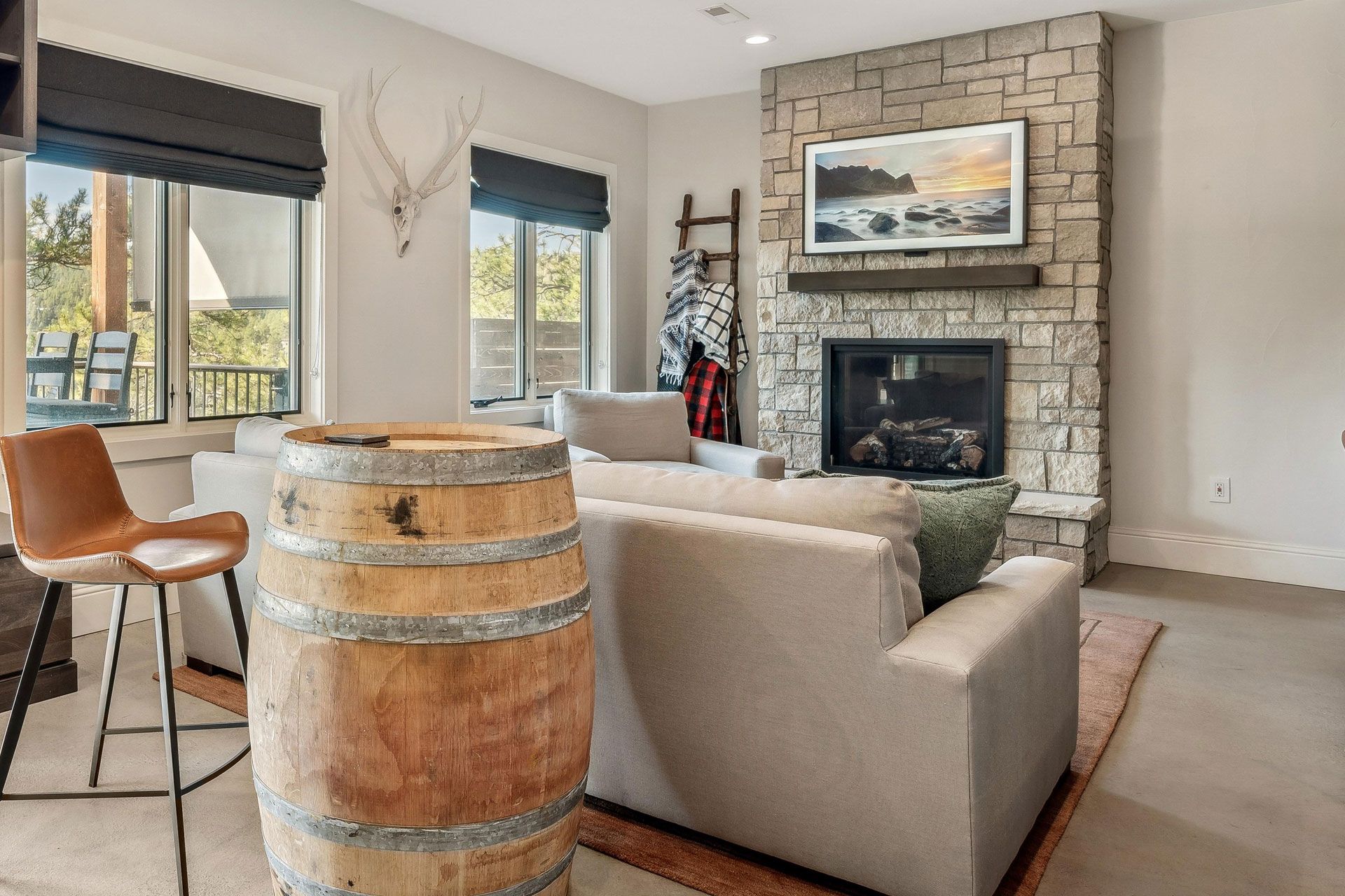 There is a wooden barrel in the middle of the living room.