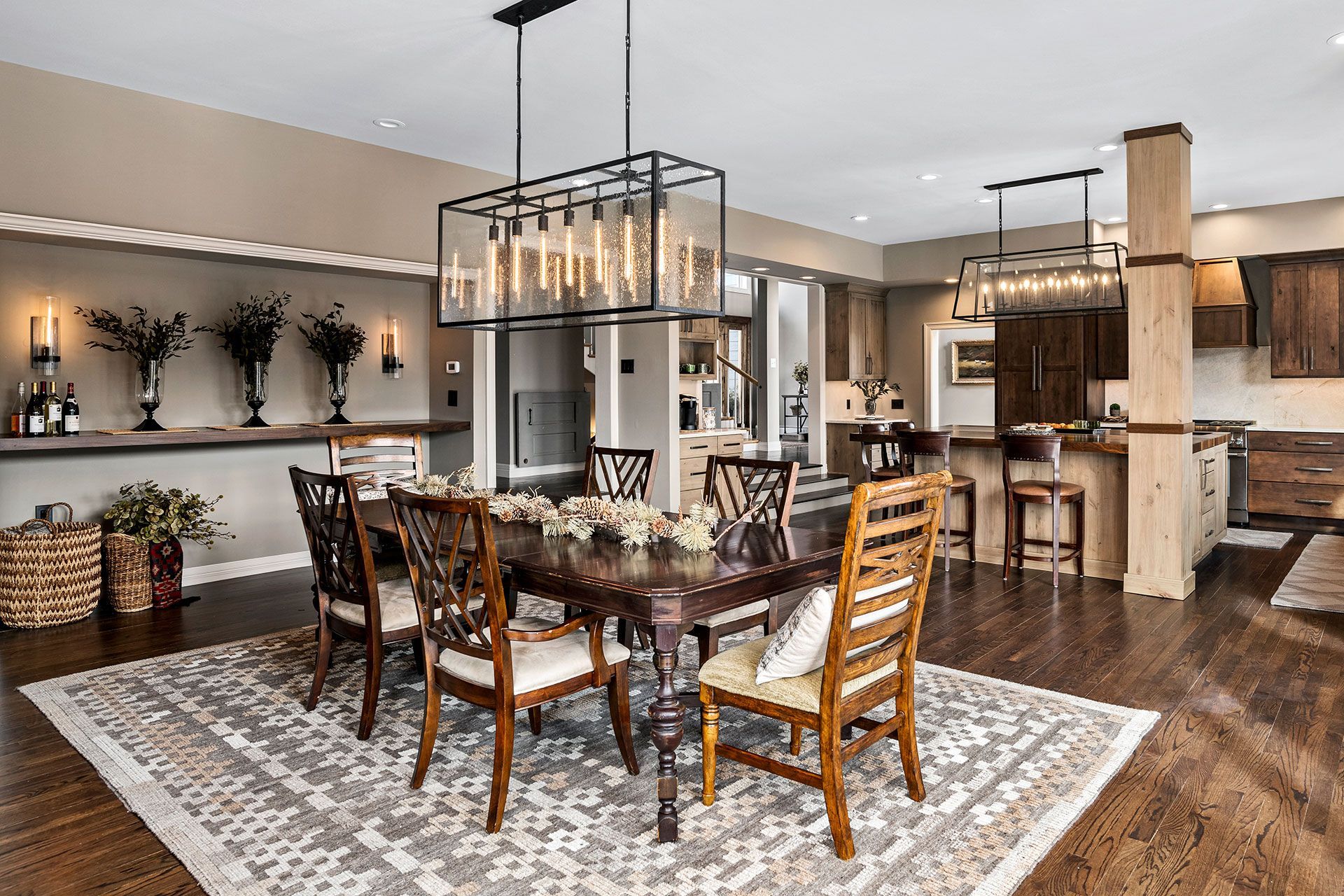 A dining room with a table and chairs and a rug.