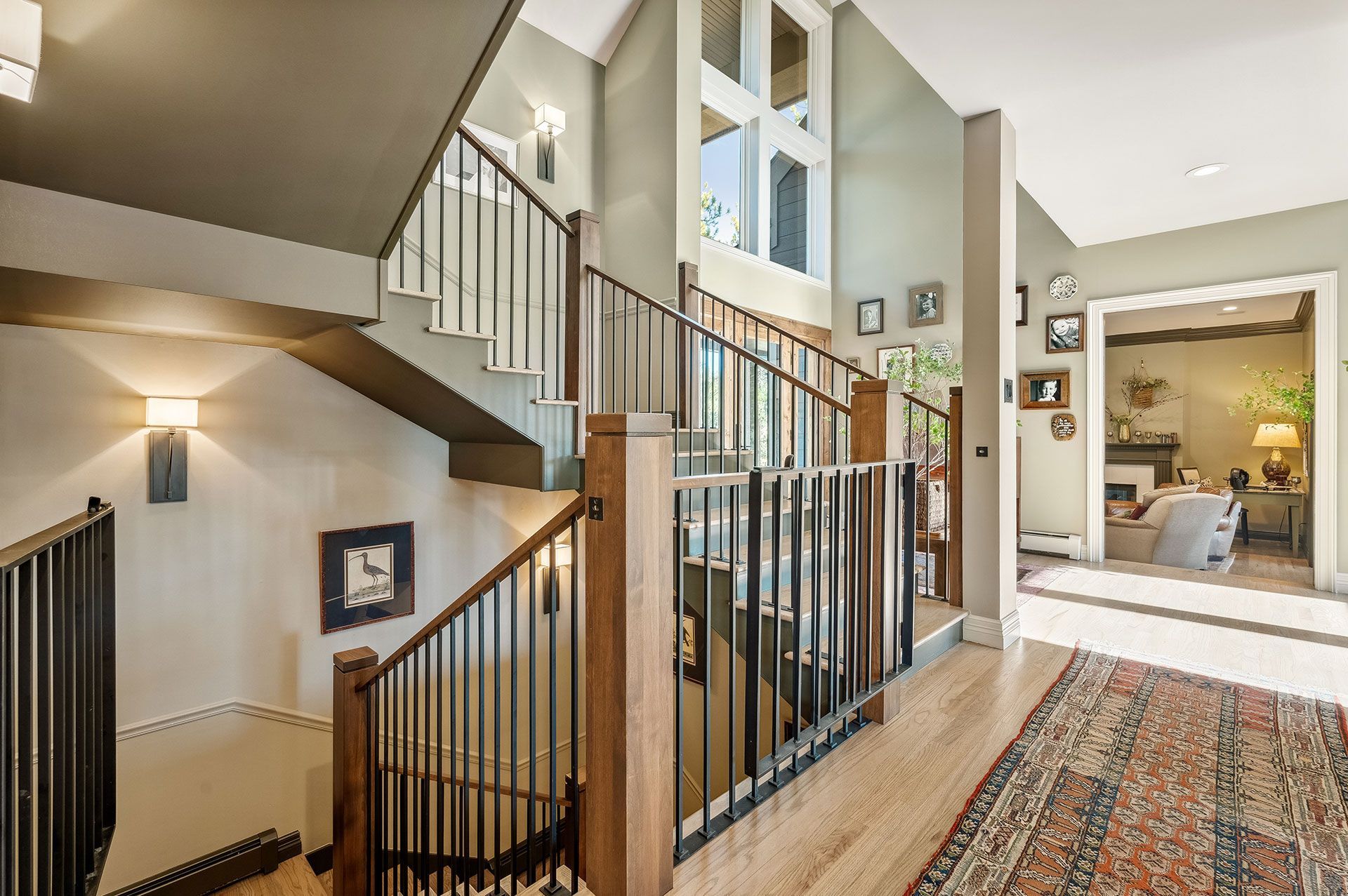 A staircase in a house with a rug on the floor.