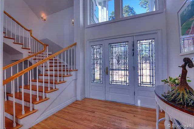 A hallway with stairs leading up to the second floor of a house.