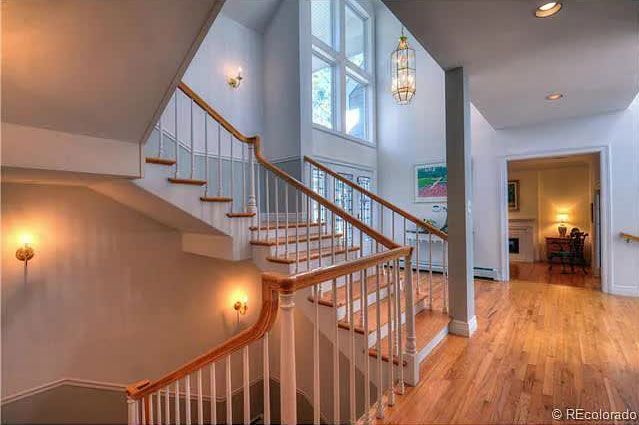A staircase in a house with wooden steps and a white railing.