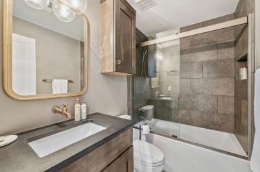 A bathroom with a sink , toilet , and shower.