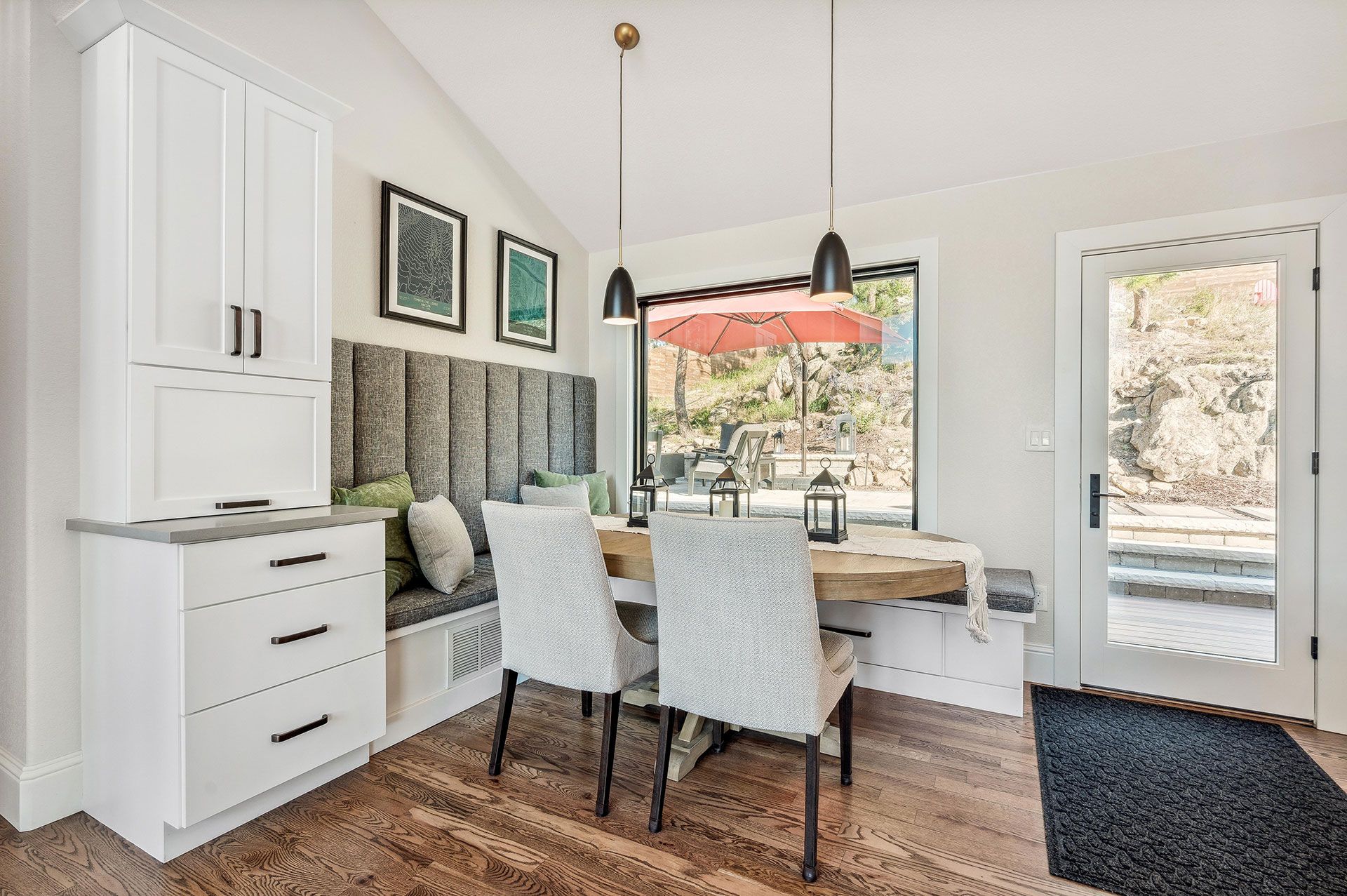 A dining room with a table and chairs and a window.