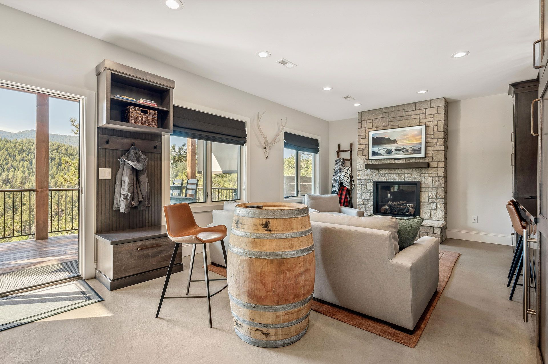 A living room with a barrel in the middle of it and a fireplace.