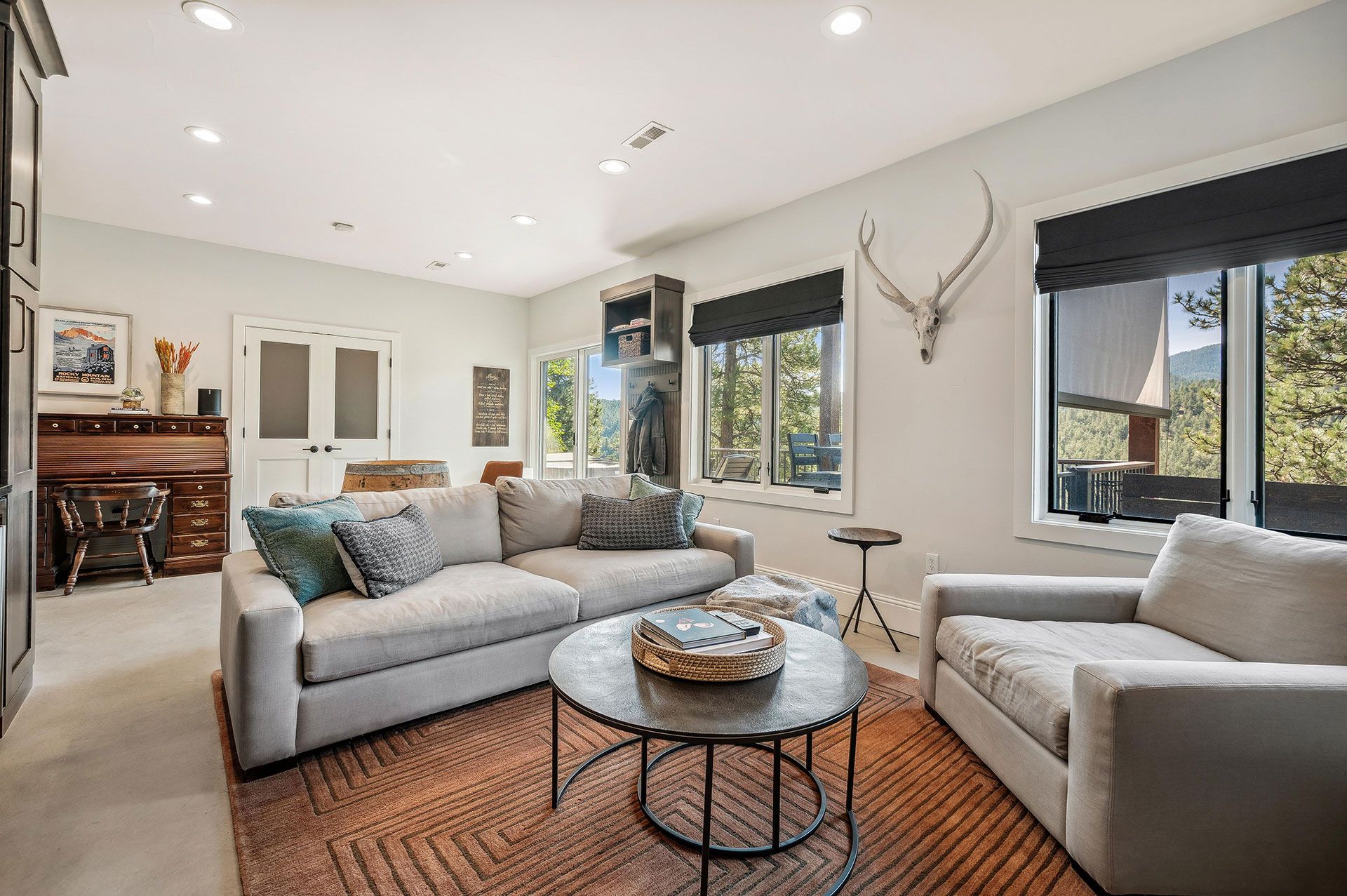 A living room with a couch , two chairs and a coffee table.